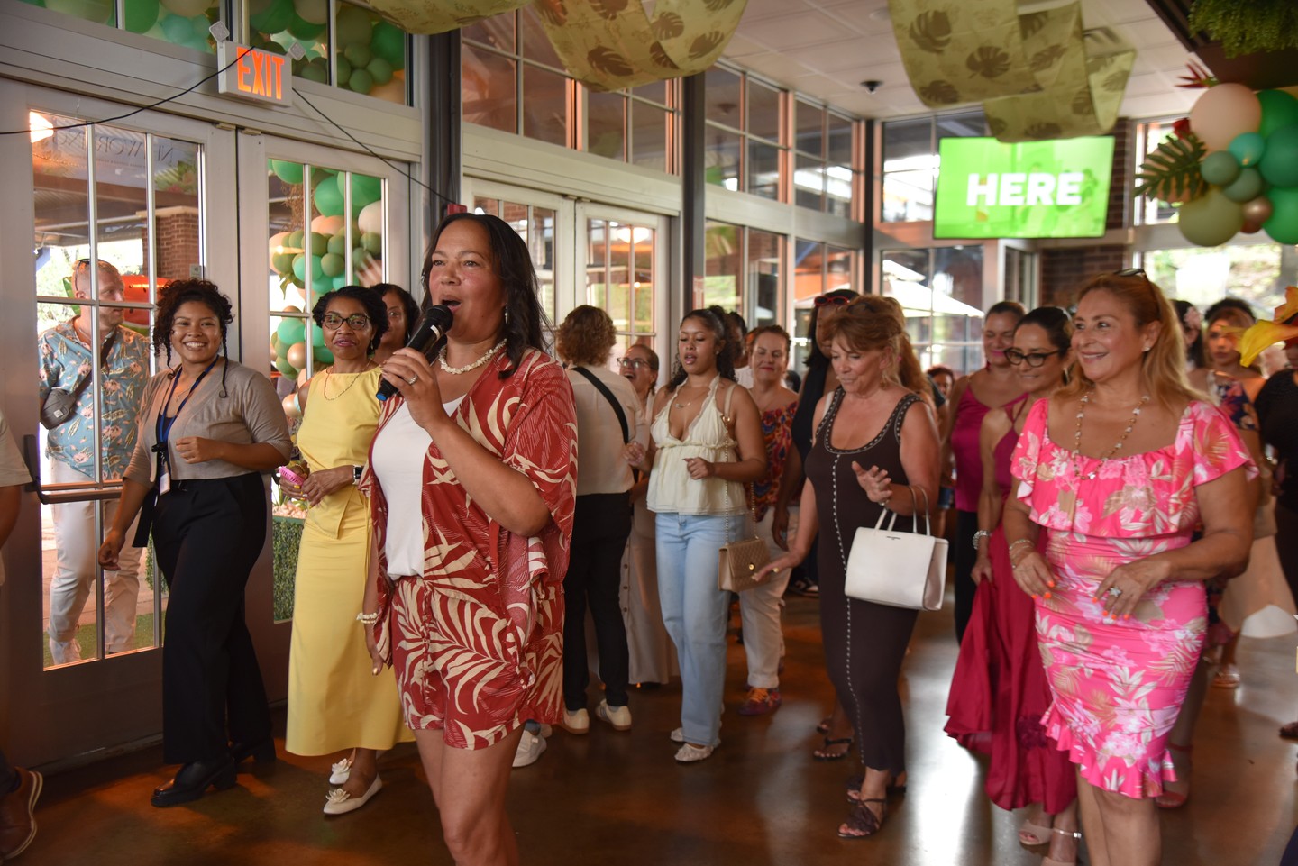 Crowd line dancing outdoors at night